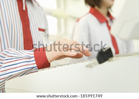 hand of convenience store salesclerk typing cash register