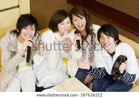 young people singing at karaoke