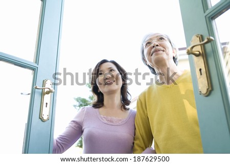 senior husband and wife opening door