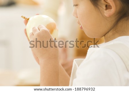 Japanese girl peeling onion skin