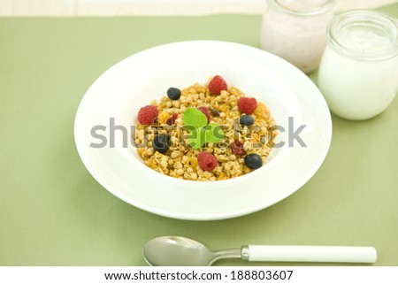 Breakfast of cereal with berries and mint leaves