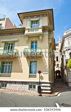 Beautifu, ornamental, mint green balconies and window panels on a beige building Monaco.