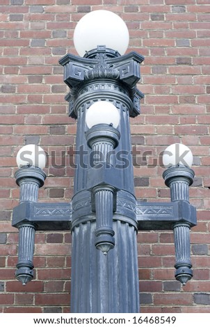 Wrought Iron lamp against a brick backdrop