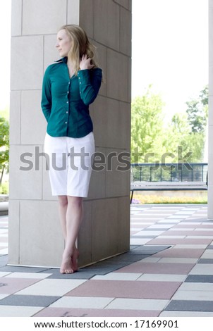 Young female posing outside with shorts and top with no shoes