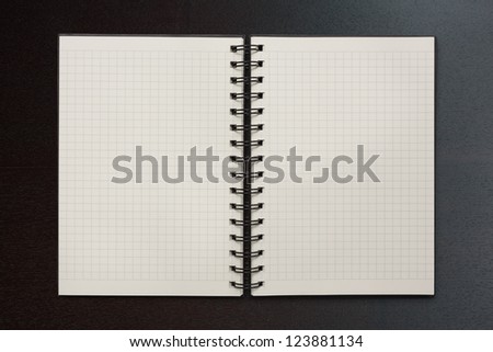 checked notepad on wood background