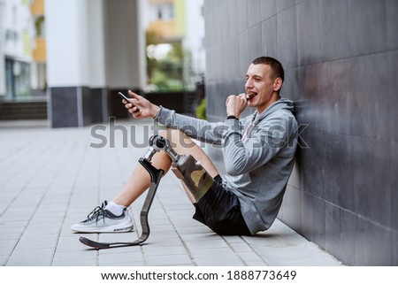 Similar – Image, Stock Photo Disabled athlete using phone