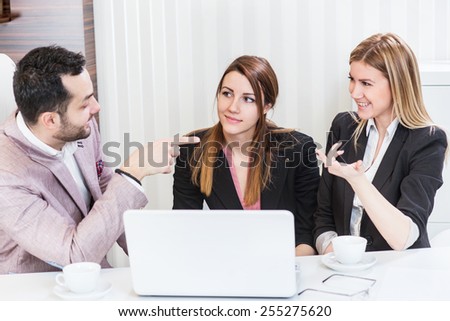 Business meeting, casual conversation at office, one man two beautiful females.