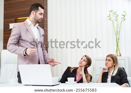 Confident businessman and his partners discussing something, he holds a master sentence.