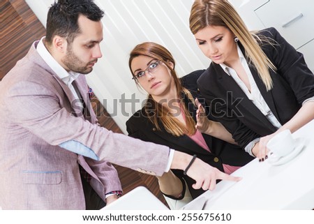 Director finger pointing at paper document, and female are surprised.