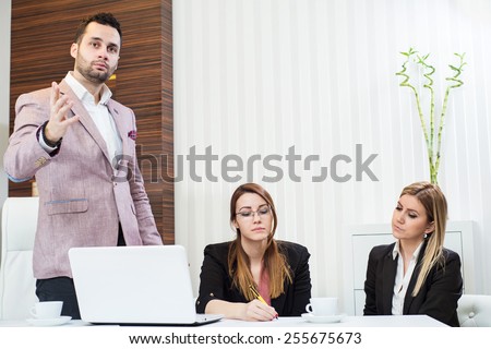 Confident businessman and his partners discussing something, he holds a master sentence.