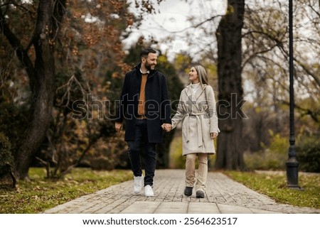 Similar – Image, Stock Photo Romantic couple walking on foamy sea waves