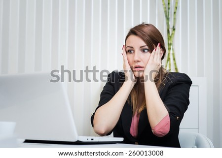 Bad day at work, stressed business woman looking at laptop. Office.