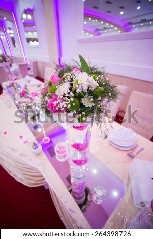 Wedding table decoration, flowers in vase. Shallow depth of field.