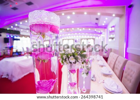 Wedding table decoration, flowers in vase full of water. Shallow depth of field.