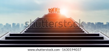 Success of business concept. Group of businessperson on the top of stairs. 商業照片 © 