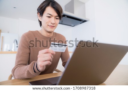 Young man using credit card. Stock foto © 