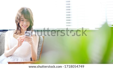 Young asian woman using a smart phone. ストックフォト © 