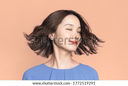 Beauty concept of a young asian woman. Hair care. Cosmetics.