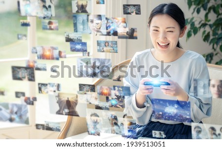 Young asian woman playing virtual reality video game. Digital contents. 商業照片 © 