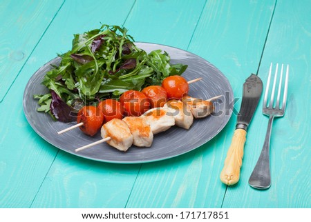 barbeque chicken with tomatoes in a plate with salad