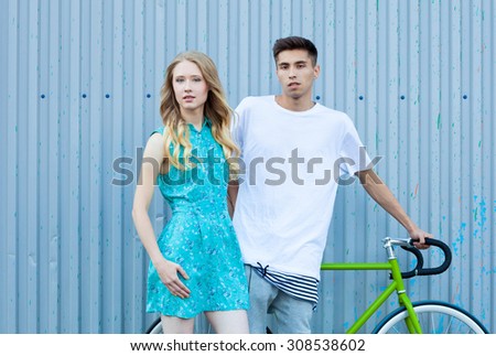Young happy hipster couple in love meet each other and dating. Pretty blonde caucasian woman with her hispanic boyfriend posing outdoor in summer