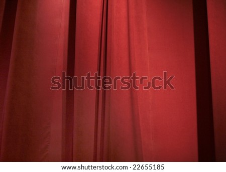 a closed dark red curtain on stage