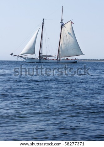 One Old Fashioned Sailboat Schooner On A Blue Sea Clear Day Stock Photo ...