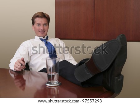 thirties business man with his feet propped up on a table in an office
