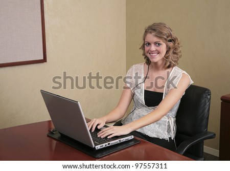 twenties blonde professional typing on a laptop computer