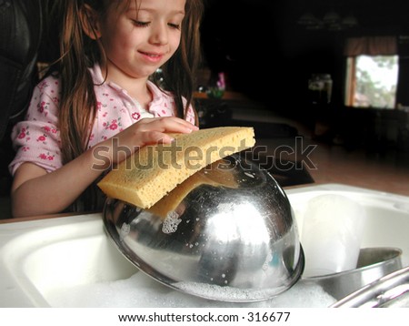 Little girl helps out with the dishes.