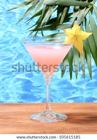 Glass of cocktail on blue sea background