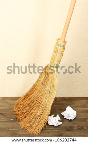 Broom and papers on floor in room
