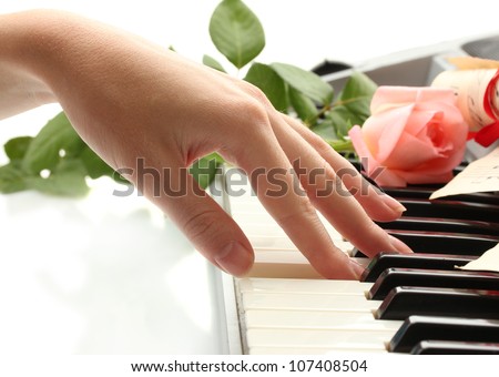 hand of woman playing piano