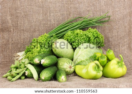 fresh green vegetables on sackcloth background