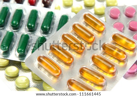 Capsules and pills packed in blisters, close up