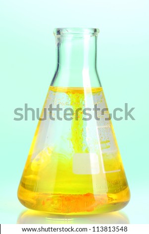 brightly ink in a flask with water  on blue background