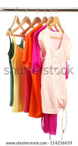 different clothes on wooden hangers isolated on white
