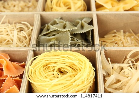 Nine types of pasta in wooden box sections close-up