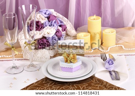 Serving fabulous wedding table in purple and gold color on white and purple fabric background
