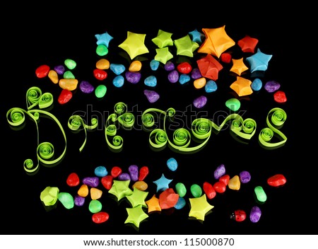 The word Dreams with colorful paper stars with dreams isolated on black