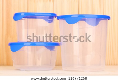 Plastic containers for food on wooden background