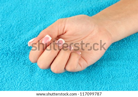woman\'s hand on blue terry towel, close-up