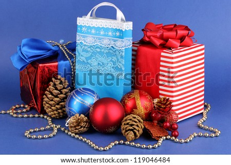 New Year composition of New Year\'s decor and gifts on blue background