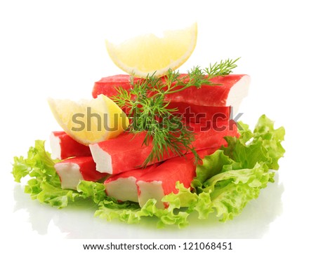 Crab sticks on lettuce leaves with lemon, isolated on white