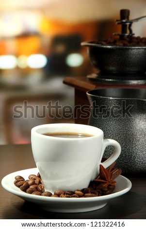 cup of coffee, grinder, turk and coffee beans in cafe