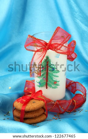 Cookies for Santa: Conceptual image of ginger cookies, milk and christmas decoration on blue background