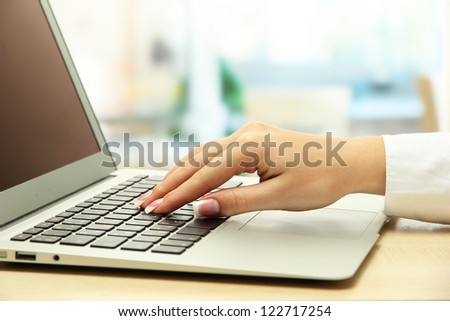 female hand writing on  laptot, close up