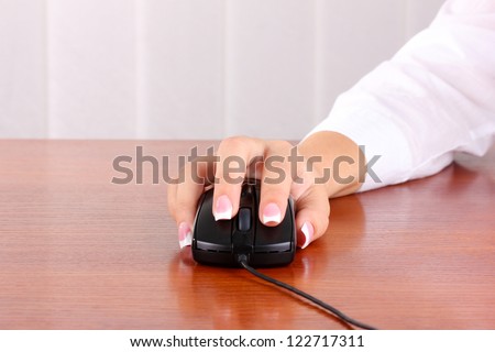 woman\'s hands pushing keys of pc mouse, close-up