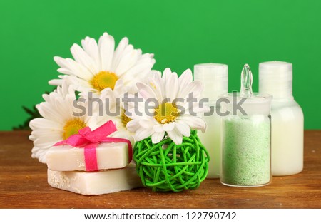 ingredients for soap making on green background