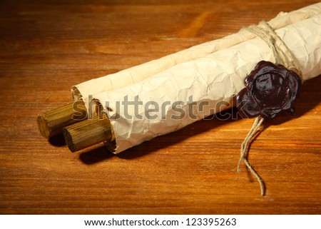Old scroll, on wooden background